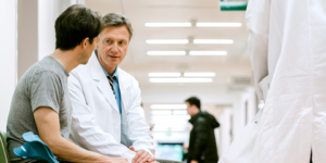 Doctor speaking to patient with crutches