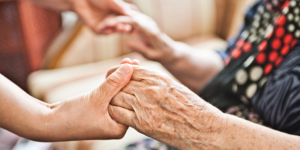 Older woman having her hand held