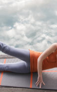 Woman on Yoga Mat with Orange Shirt